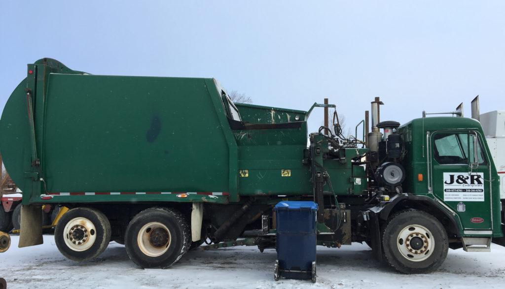 green garbage truck powered by natural gas